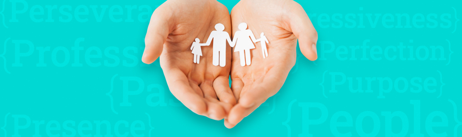 Cupped hands holding a paper cut out of a family