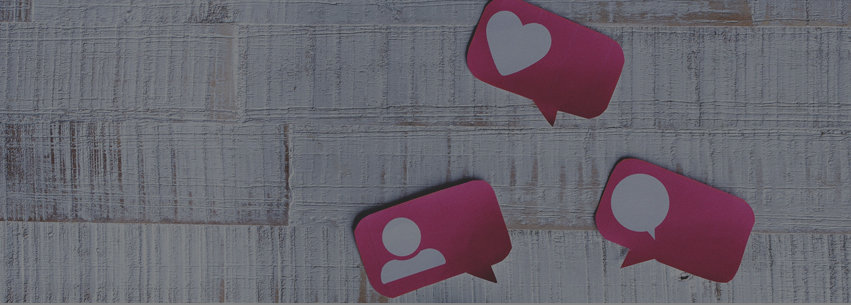Pink speech bubbles on painted wood